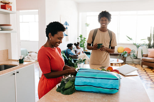 Happy mom cooking for her family at home