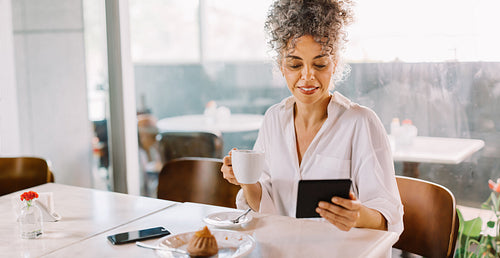 Female entrepreneur browsing the internet during lunch