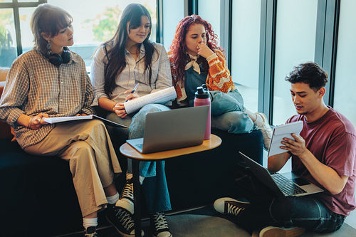 Diverse group of college students in a library study session