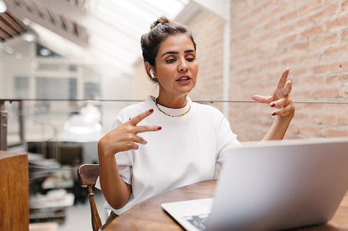 Female small business owner having an online meeting in a warehouse