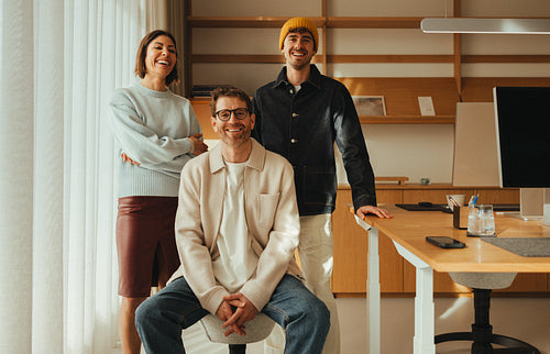 Business team photo: three coworkers together in an office