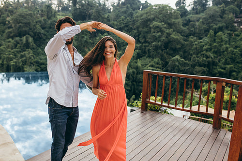 Couple in love dancing near swimming pool