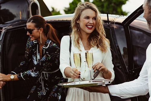 Man greet guests with drinks
