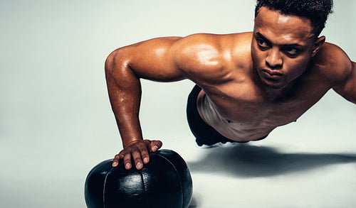 Young man exercising with a medicine ball