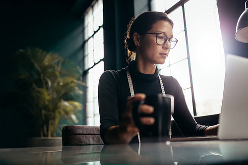 Young designer working on laptop computer