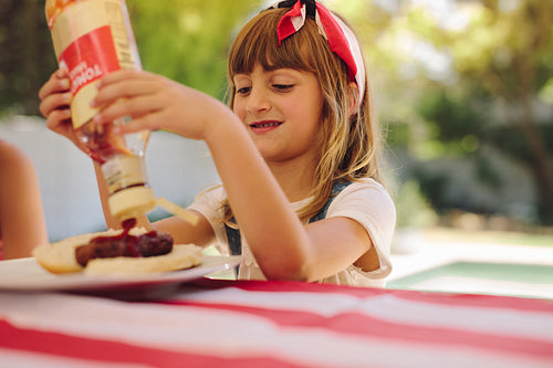Girl sitting at the dining table with food