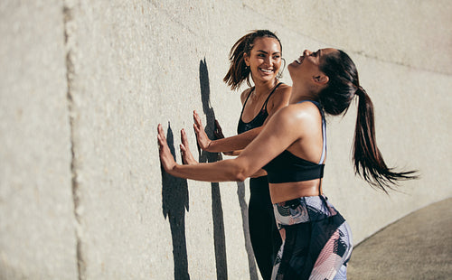 Female friends exercising together in morning