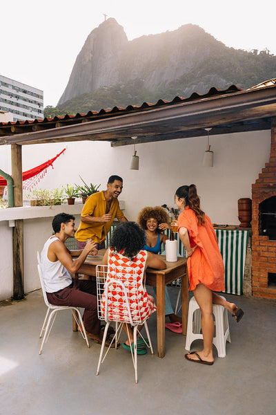 Friends enjoy outdoor gathering under Corcovado hill in Rio de Janeiro
