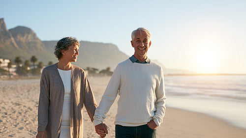 Senior couple enjoying a stroll on the beach