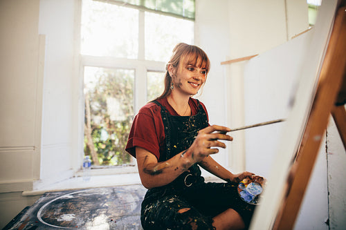 Female artist painting in studio