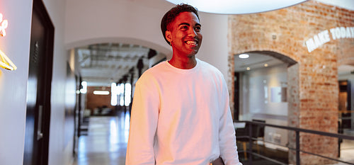 Creative businessman smiling in a modern workplace