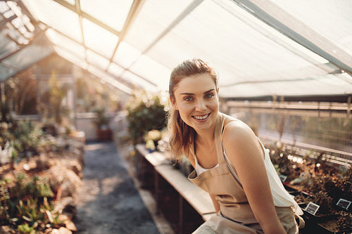 Beautiful woman working in greenhouse