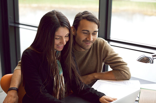 Two young students studying together in library