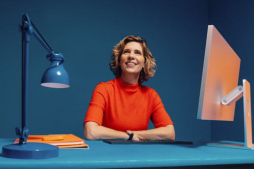 Confident mature manager in a vibrant color blocking office shot