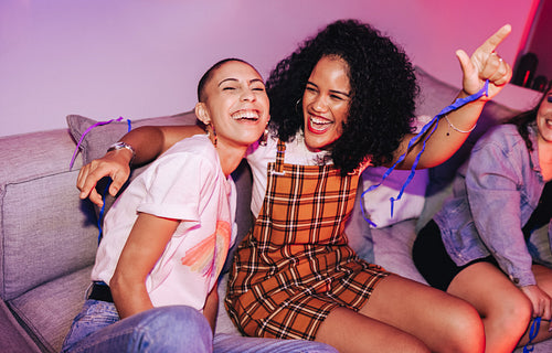 Vibrant female friends having a good time at a house party