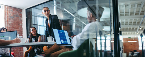 Young businesswoman addressing her colleagues during a meeting