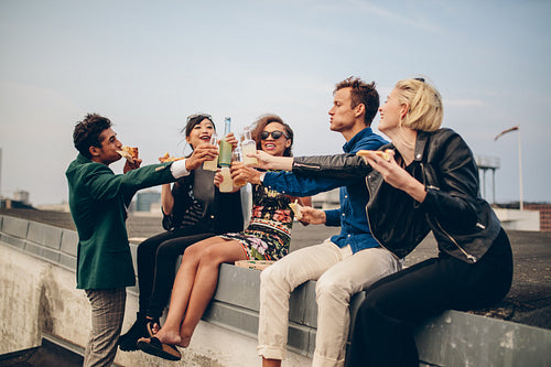 Group of friends celebrating on rooftop