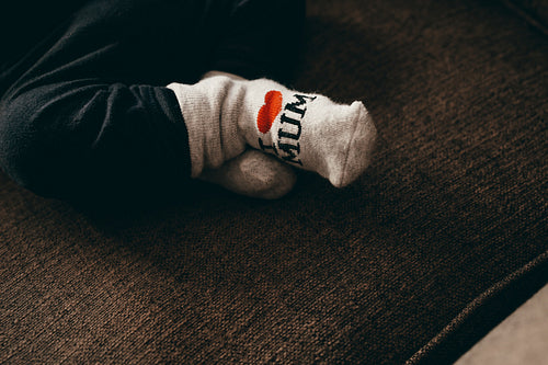 Close up of legs of a baby  wearing socks
