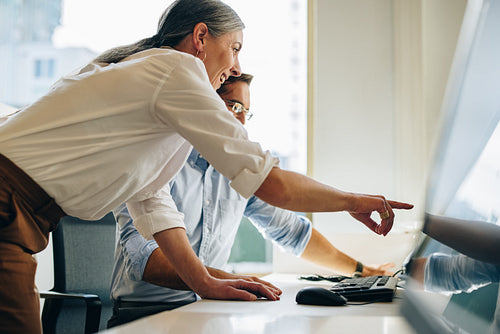 Manager suggesting some changes on the report to coworker
