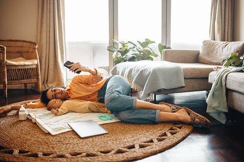 Mother and baby lounge at home and take selfie