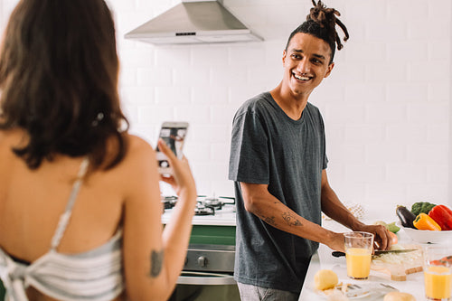 Couple recording content for a cooking blog at home