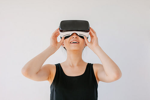 Young woman using the virtual reality headset and smiling