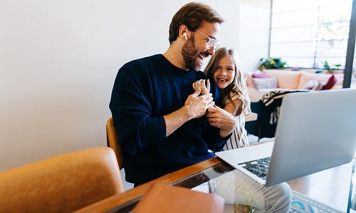 Father and daughter joyfully interact on video call