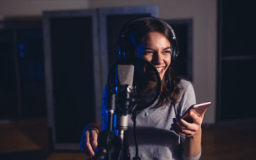 Female singer singing in recording studio
