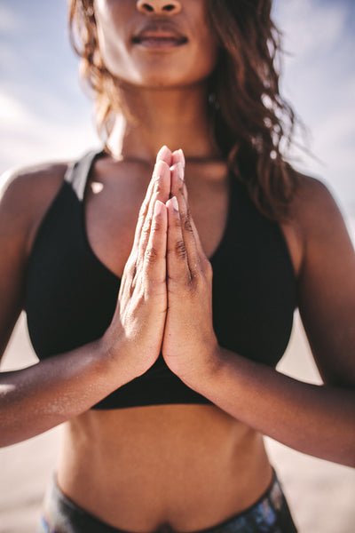 Fitness woman meditating outdoors