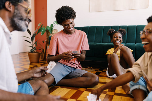 Happy family playing a fun card game in their living room