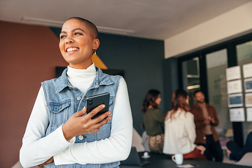 Pensive businesswoman looking away with a smile