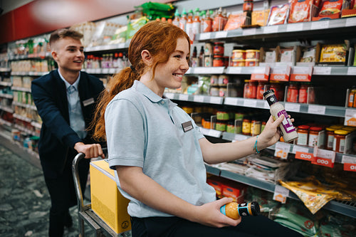 Supermarket employees having fun while working