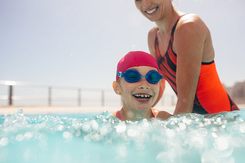 Girl learning to swim in a pool