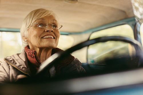 Senior woman carefully driving a car