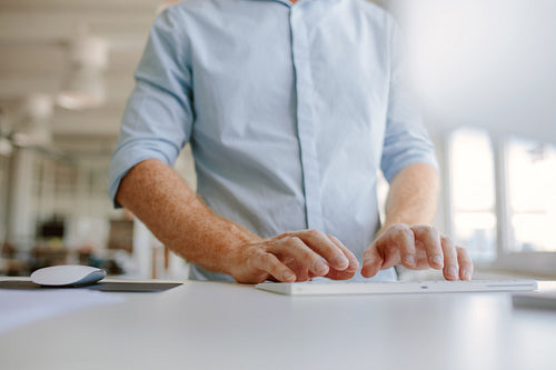 Businessman hands typing on computer keyboard