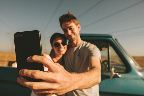 Couple on a road trip taking selfie