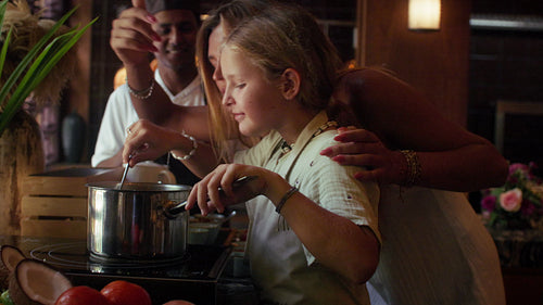 Mother and Daughter learning to cook on vacation