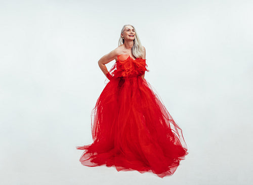 Beautiful senior woman in a red evening gown