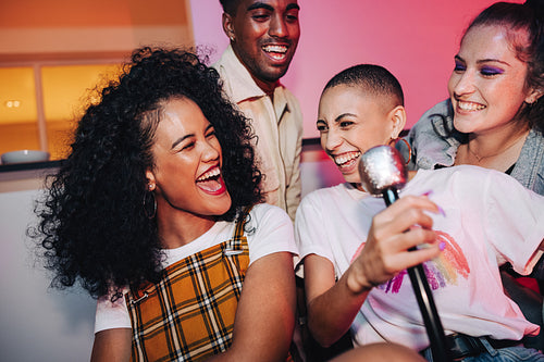 Ecstatic friends enjoying karaoke night