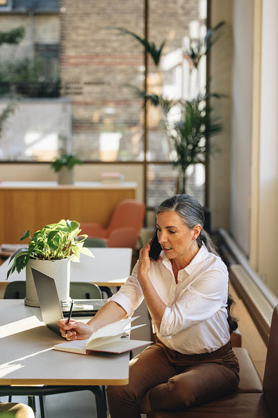 Entrepreneur talking on cell phone in office