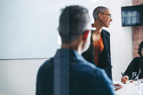 Cheerful businesswoman leading a meeting with her colleagues
