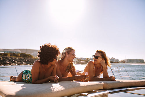 Female friends relaxing on a yacht deck