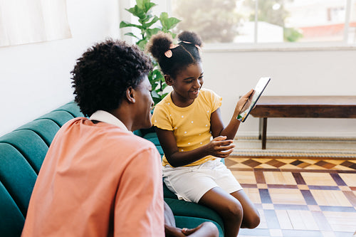 Brother and sister spending quality time together, enjoying entertainment with a tablet