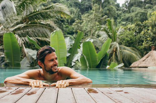 Man in pool at luxury holiday resort