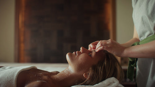 Woman enjoying a relaxing facial massage treatment at a luxurious spa for wellness