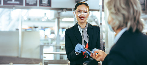 Airport security personnel checking in flight passenger