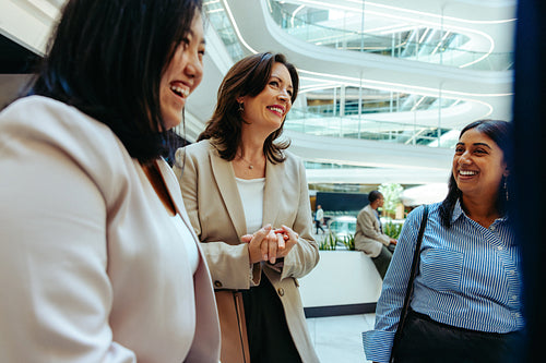 Female professionals engaged in a vibrant corporate conversation