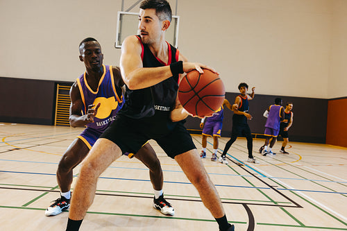 Basketball game with young male players