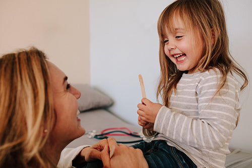 Girl visiting her pediatrician for throat checkup