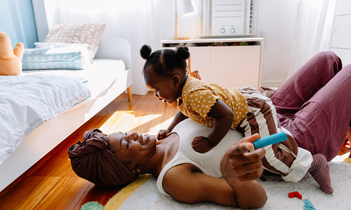 Mom and baby playing on floor together